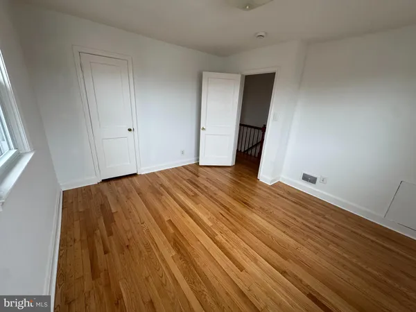 a view of a room with wooden floor and staircase