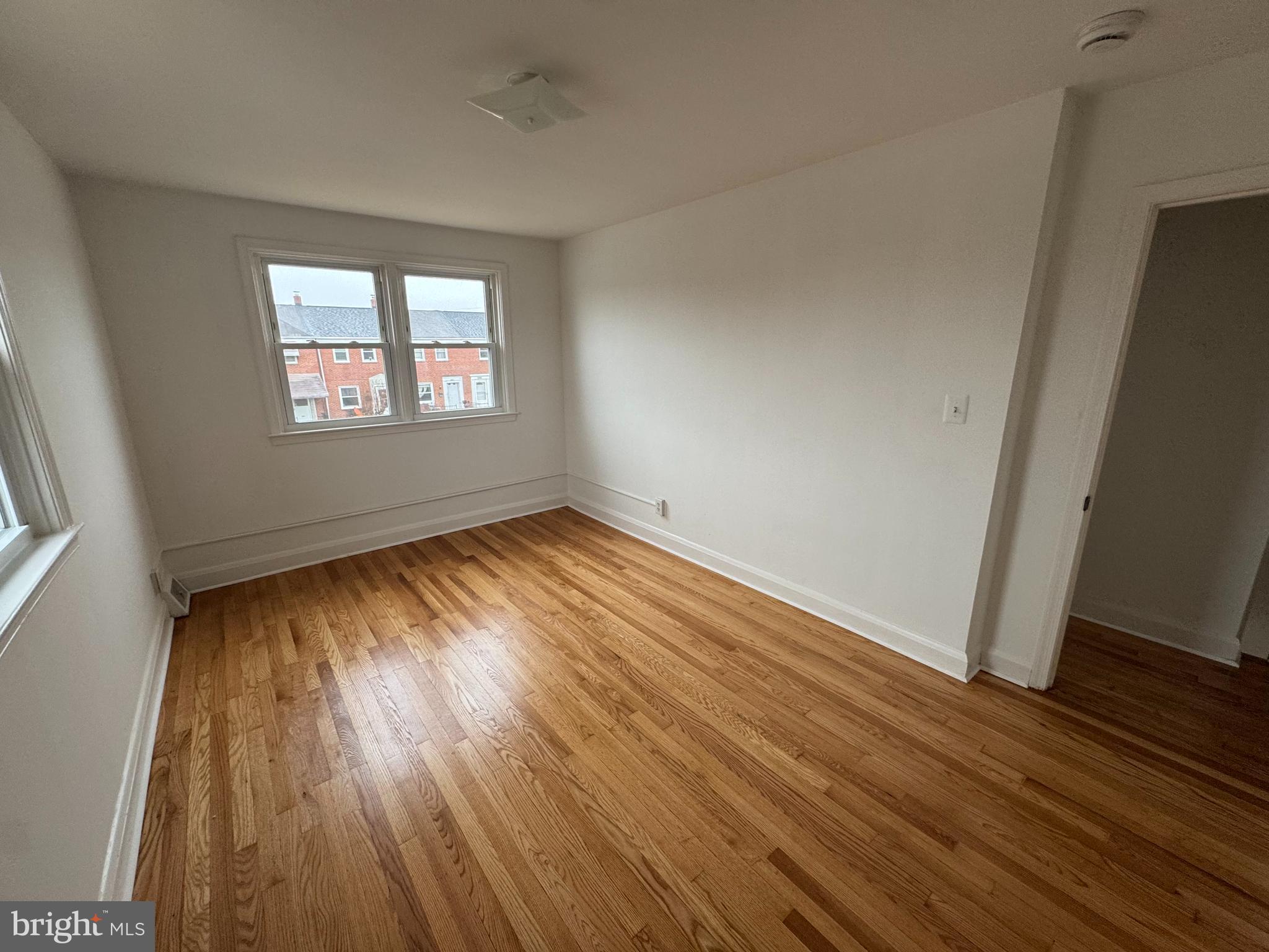 2167 Coralthorn Road Middle River, MD 21220 - Photo 21 of 23 an empty room with wooden floor and windows