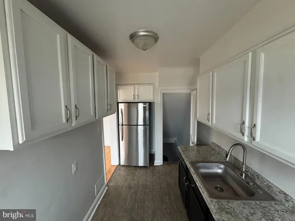 a kitchen with a sink stove and refrigerator