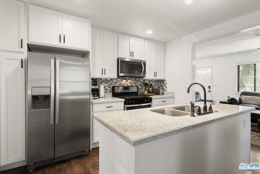 53335 Meadow Drive Idyllwild, CA 92549 - Photo 15 of 35 a kitchen with refrigerator a stove and a microwave