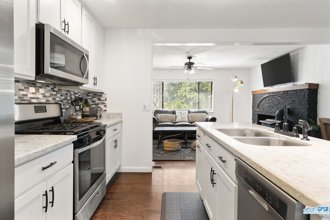 53335 Meadow Drive Idyllwild, CA 92549 - Photo 16 of 35 a kitchen with a sink stove and microwave