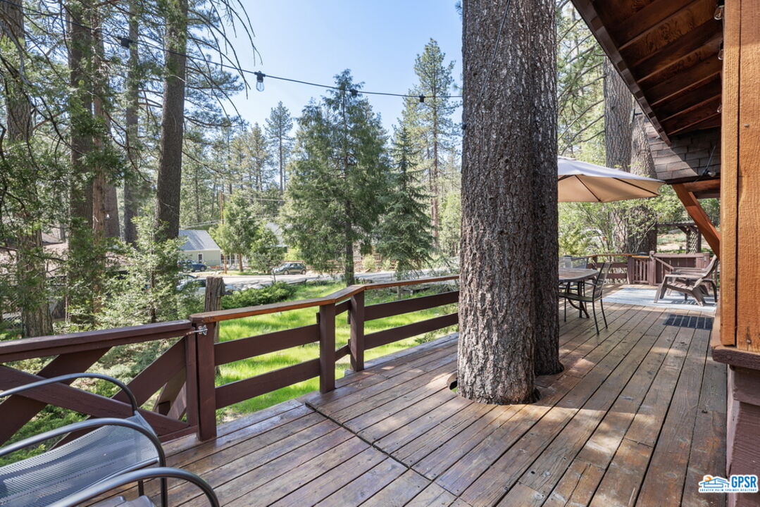 53335 Meadow Drive Idyllwild, CA 92549 - Photo 8 of 35 a view of a wooden deck with a bench