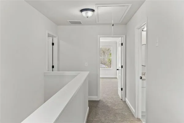 a white toilet sitting next to a white wall