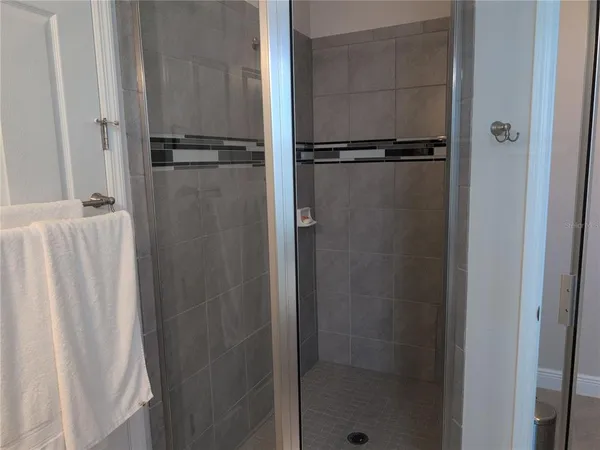 a bathroom with a glass shower door