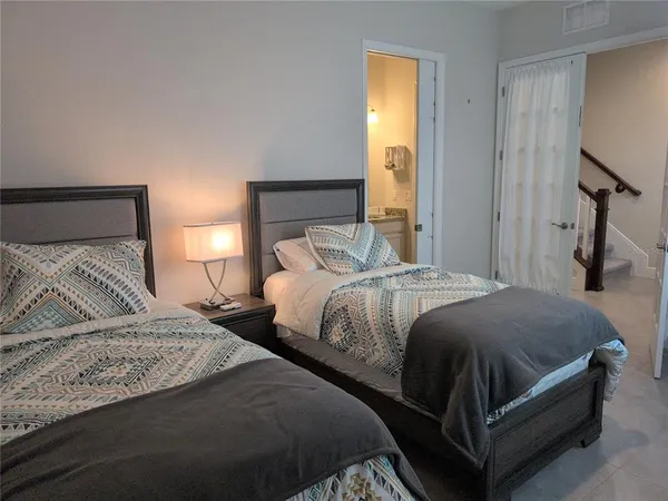 a bedroom with a bed and a mirror