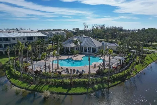 an aerial view of a house with a garden and lake view