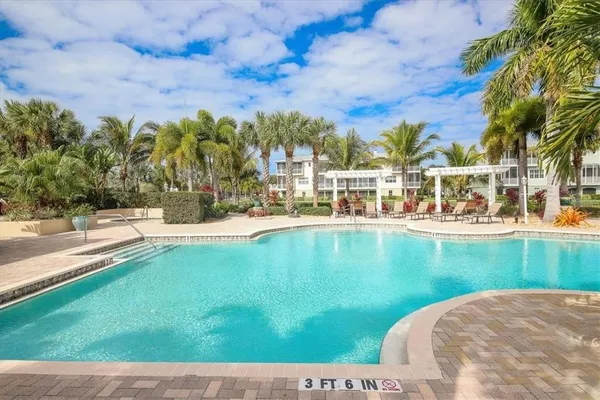 a swimming pool with outdoor seating and yard