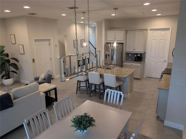 a large kitchen with a table and chairs