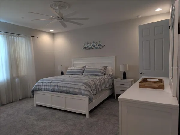 a bedroom with bed and a chandelier