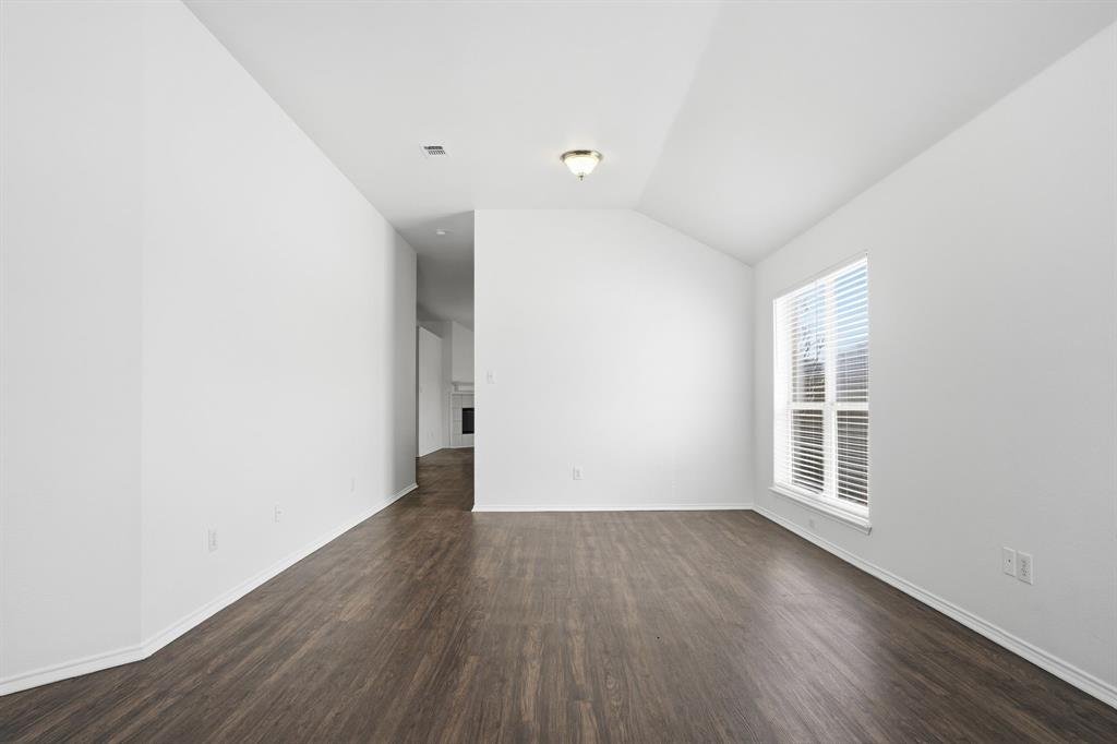 1000 Caleb Street Burleson, TX 76028 - Photo 11 of 27 an empty room with wooden floor and windows