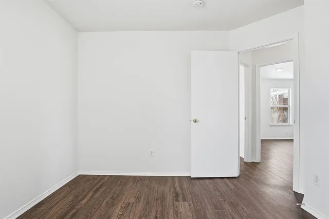 a view of a room with wooden floor
