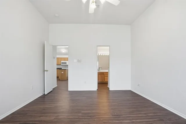 a view of empty room with wooden floor