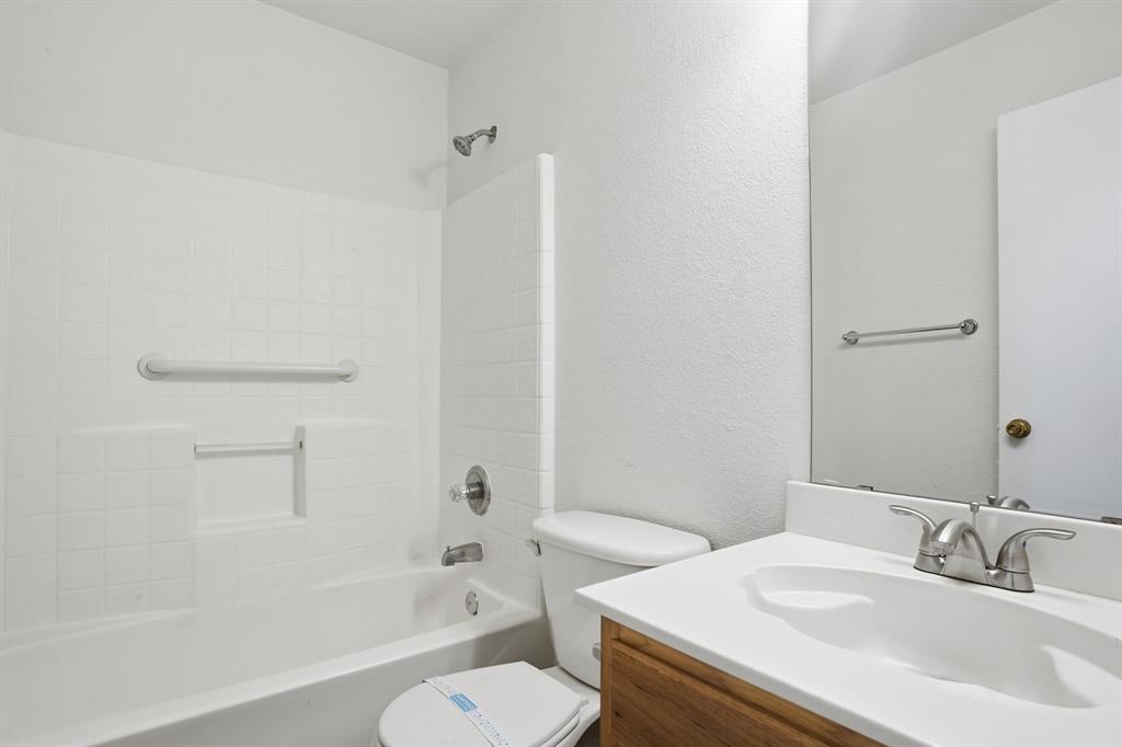 1000 Caleb Street Burleson, TX 76028 - Photo 22 of 27 a bathroom with a sink toilet vanity and shower