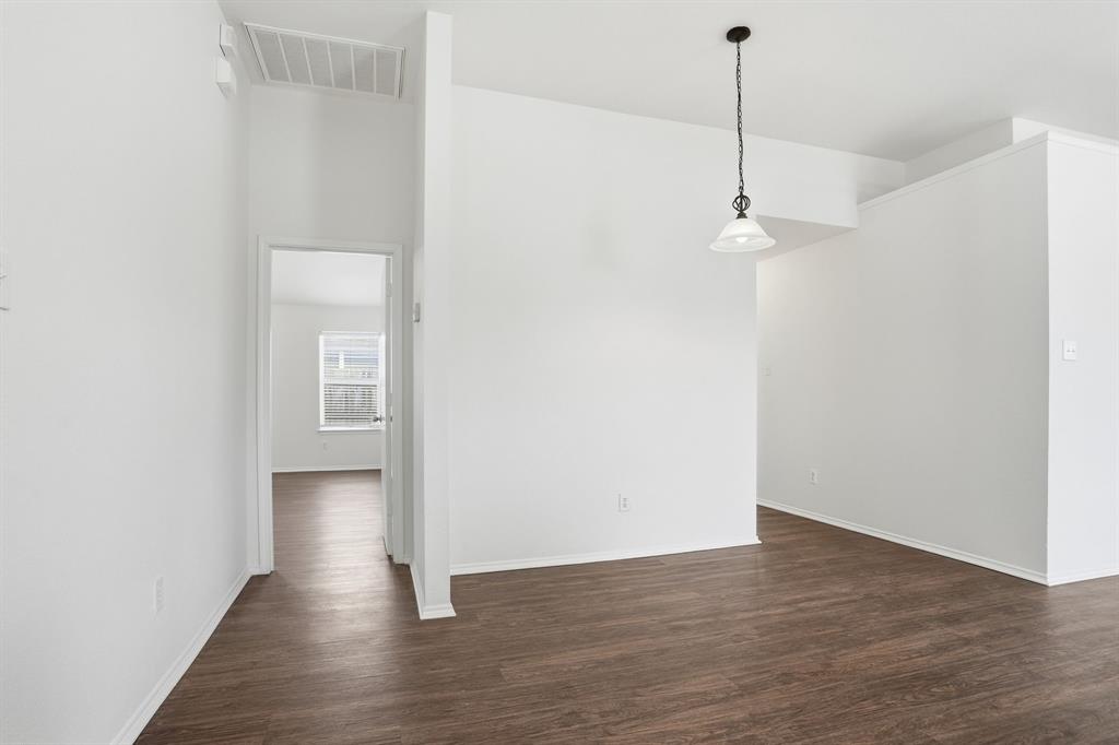 1000 Caleb Street Burleson, TX 76028 - Photo 3 of 27 a view of a room with wooden floor and white walls