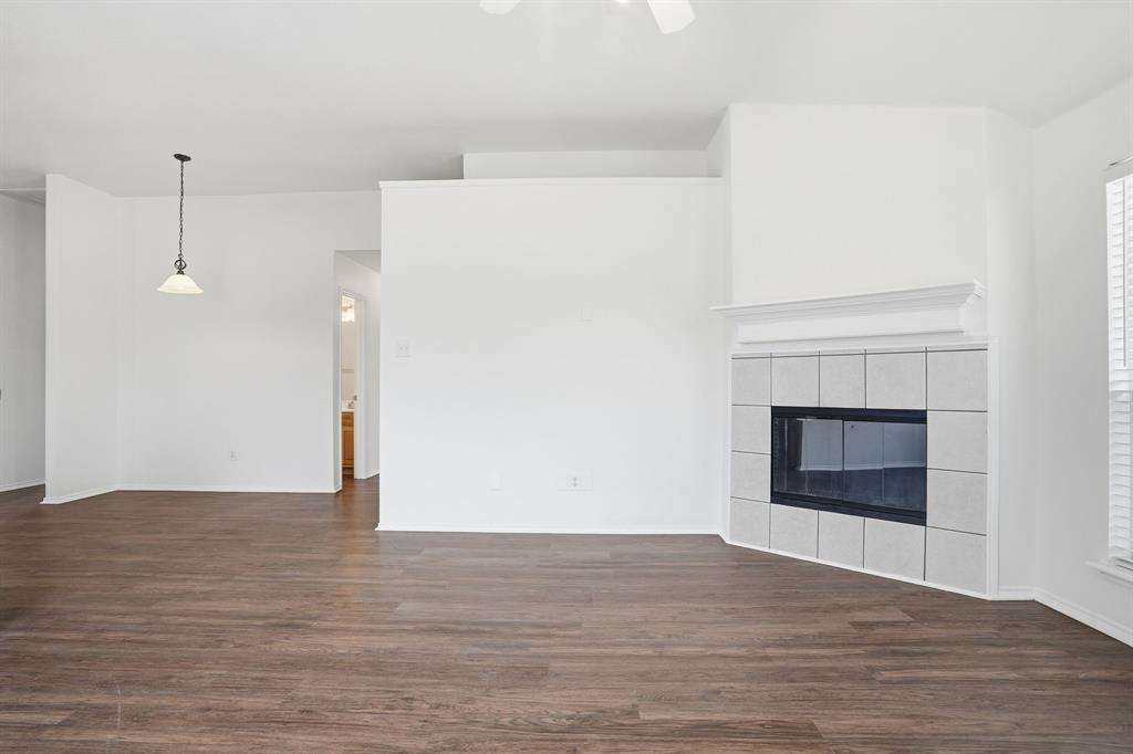 1000 Caleb Street Burleson, TX 76028 - Photo 5 of 27 a view of empty room with wooden floor and fireplace