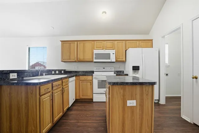 a kitchen with stainless steel appliances a refrigerator sink and cabinets
