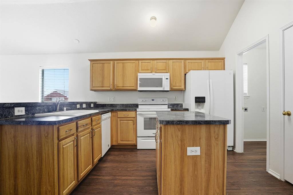 1000 Caleb Street Burleson, TX 76028 - Photo 7 of 27 a kitchen with stainless steel appliances a refrigerator sink and cabinets