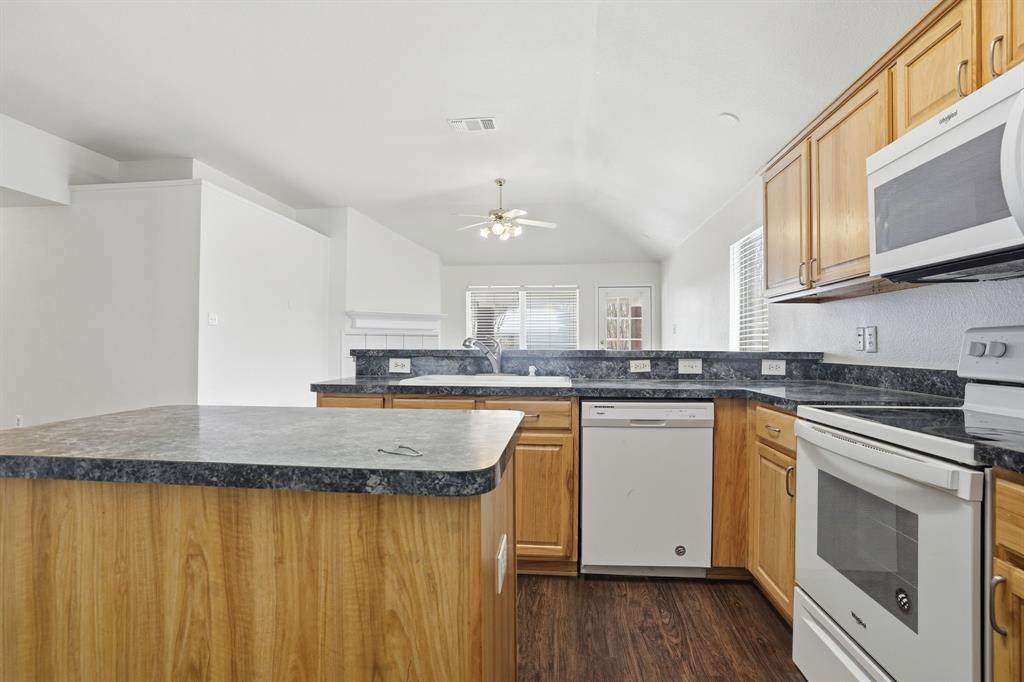 1000 Caleb Street Burleson, TX 76028 - Photo 8 of 27 a kitchen with stainless steel appliances granite countertop a stove a sink and a microwave
