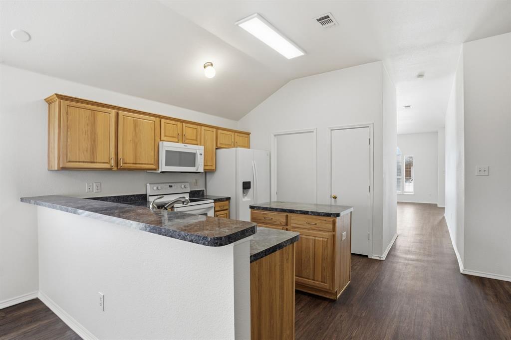 1000 Caleb Street Burleson, TX 76028 - Photo 9 of 27 a kitchen that has a sink and a stove in it