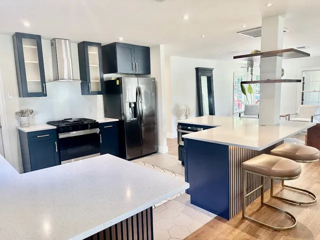 a kitchen with stainless steel appliances a refrigerator and a wooden cabinets