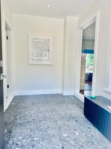 an empty room with cabinet and mirrors