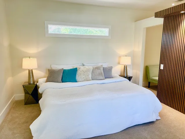 a bedroom with a bed and a night stand