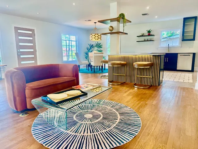 a living room with furniture and a wooden floor