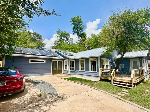 a front view of a house with a yard table and chairs