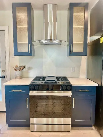 a kitchen with granite countertop a stove and a sink