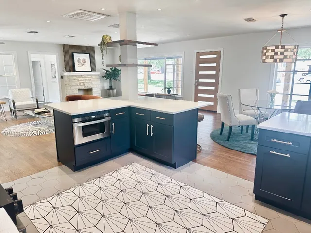 a kitchen with stainless steel appliances granite countertop a stove a sink and a refrigerator