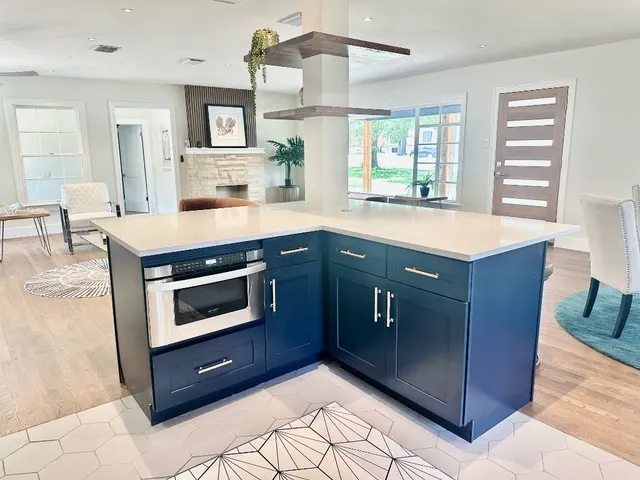 a kitchen with a stove sink and microwave