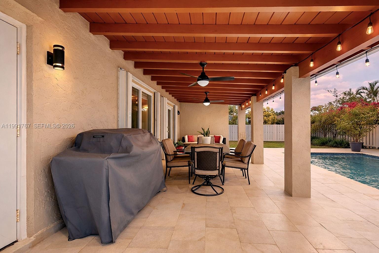 15382 Southwest 153rd Street Miami, FL 33187 - Photo 11 of 65 a view of a patio with table and chairs