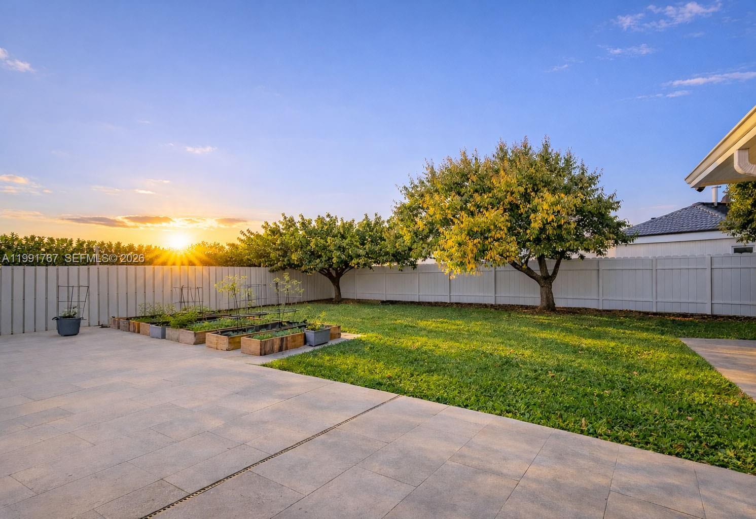 15382 Southwest 153rd Street Miami, FL 33187 - Photo 15 of 65 a view of a backyard with a garden and trees