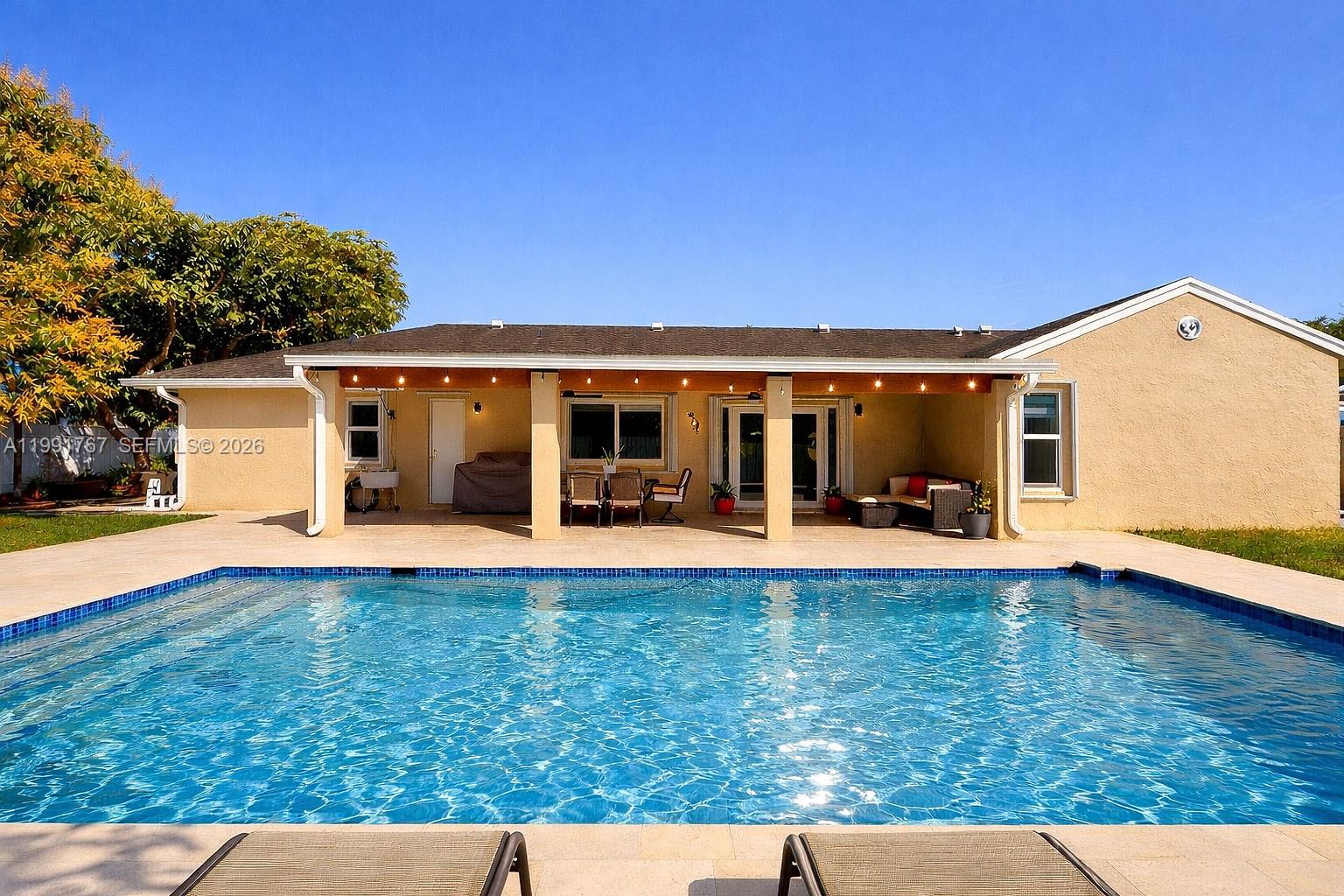 15382 Southwest 153rd Street Miami, FL 33187 - Photo 20 of 65 a view of a house with swimming pool and sitting area