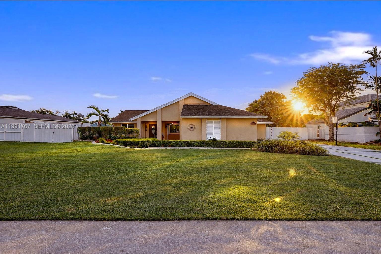 15382 Southwest 153rd Street Miami, FL 33187 - Photo 23 of 65 a front view of a house with a yard