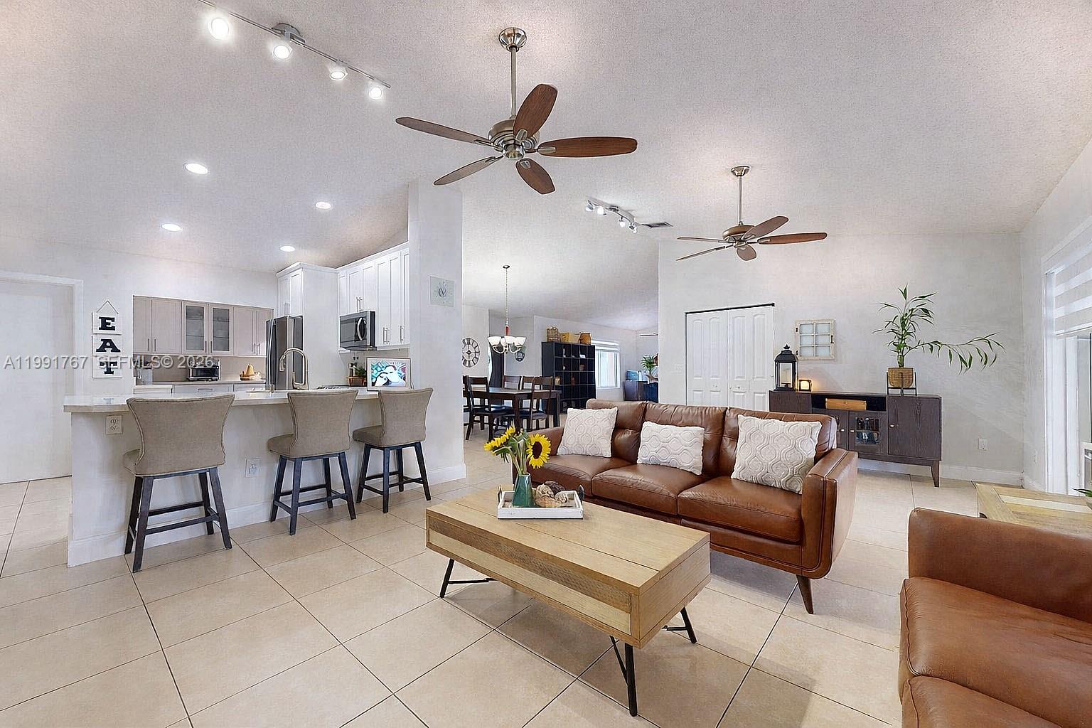 15382 Southwest 153rd Street Miami, FL 33187 - Photo 24 of 65 a living room with furniture and kitchen view
