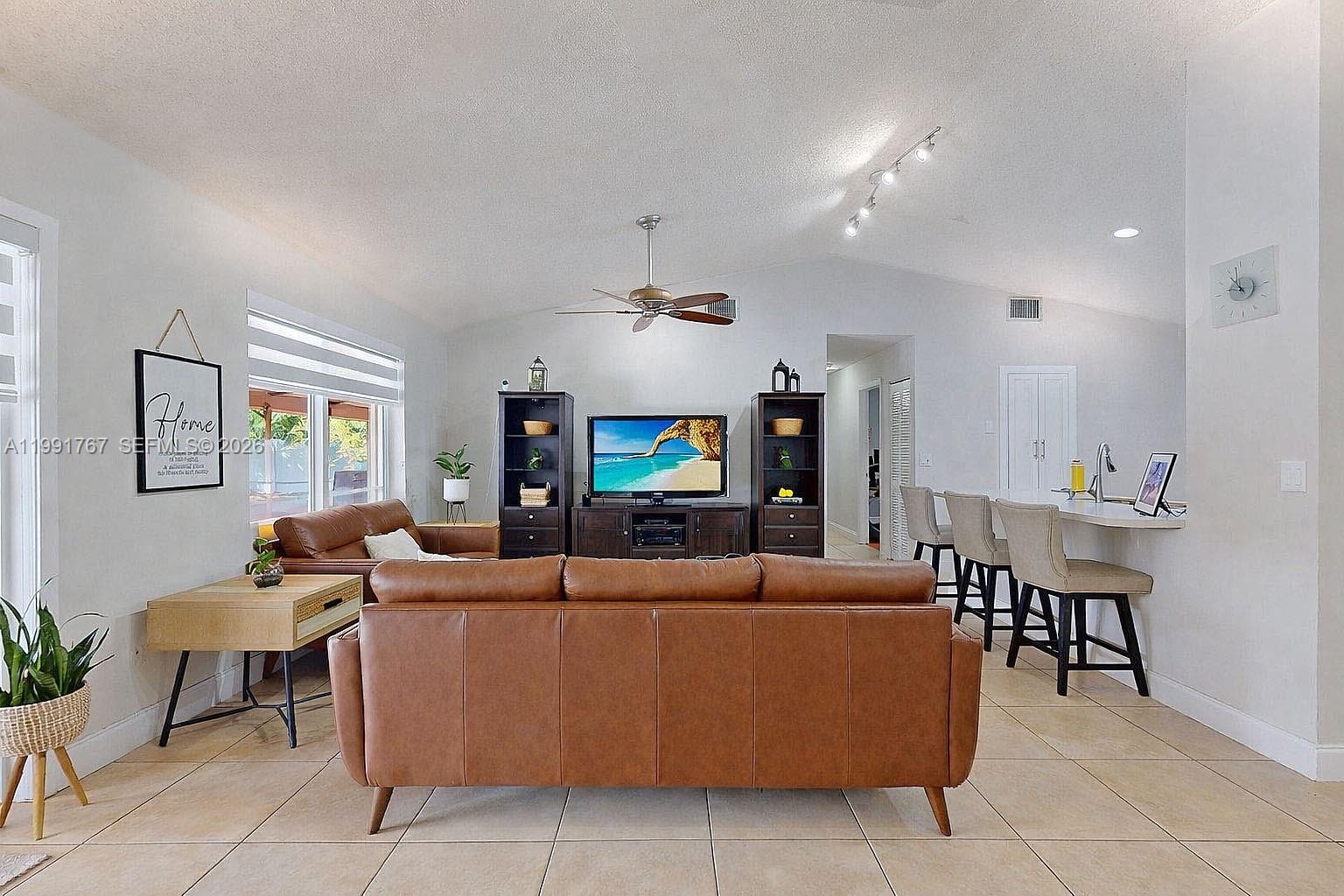 15382 Southwest 153rd Street Miami, FL 33187 - Photo 25 of 65 a living room with furniture and a flat screen tv