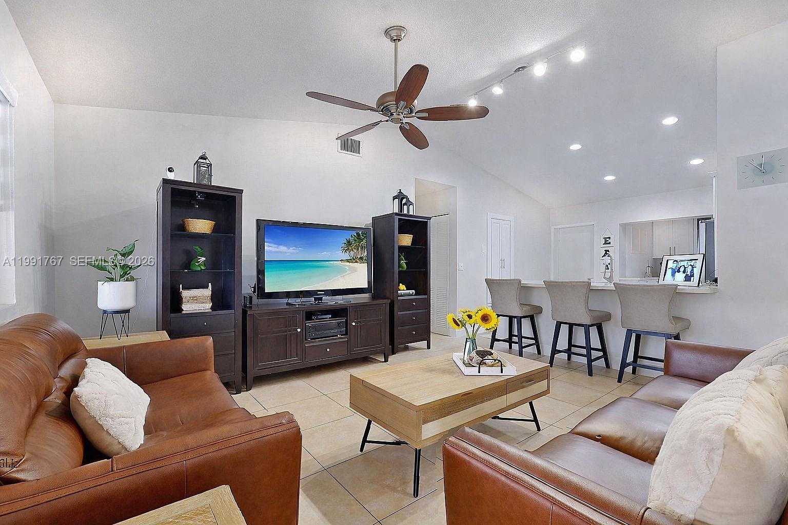 15382 Southwest 153rd Street Miami, FL 33187 - Photo 31 of 65 a living room with furniture and a flat screen tv