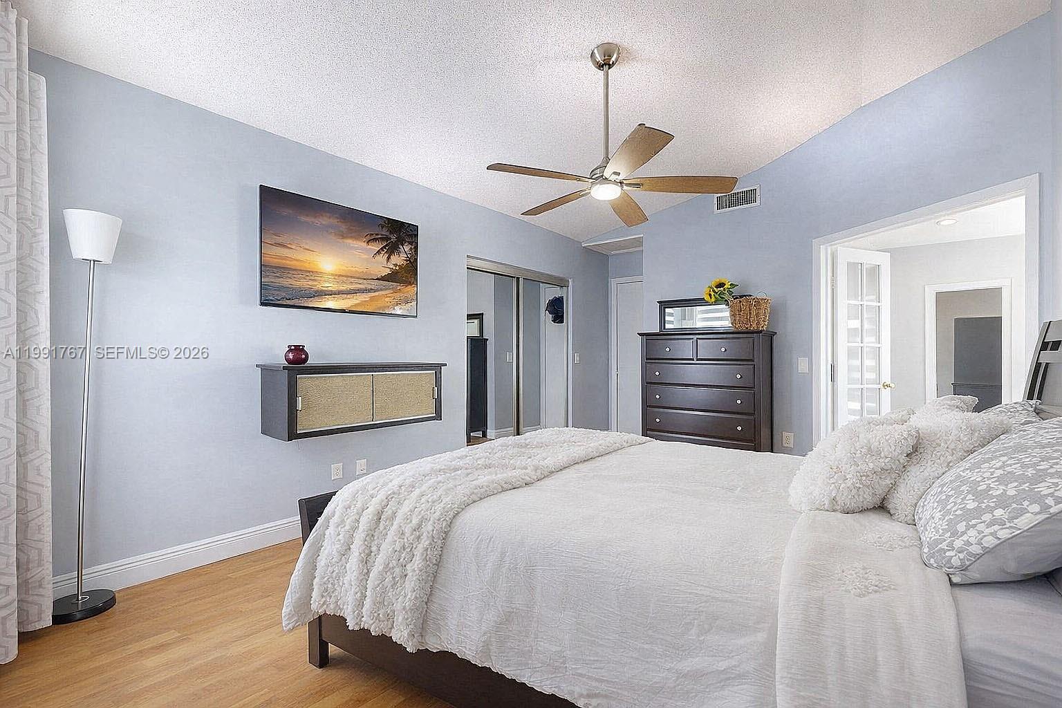 15382 Southwest 153rd Street Miami, FL 33187 - Photo 45 of 65 a bedroom with a bed and a flat screen tv