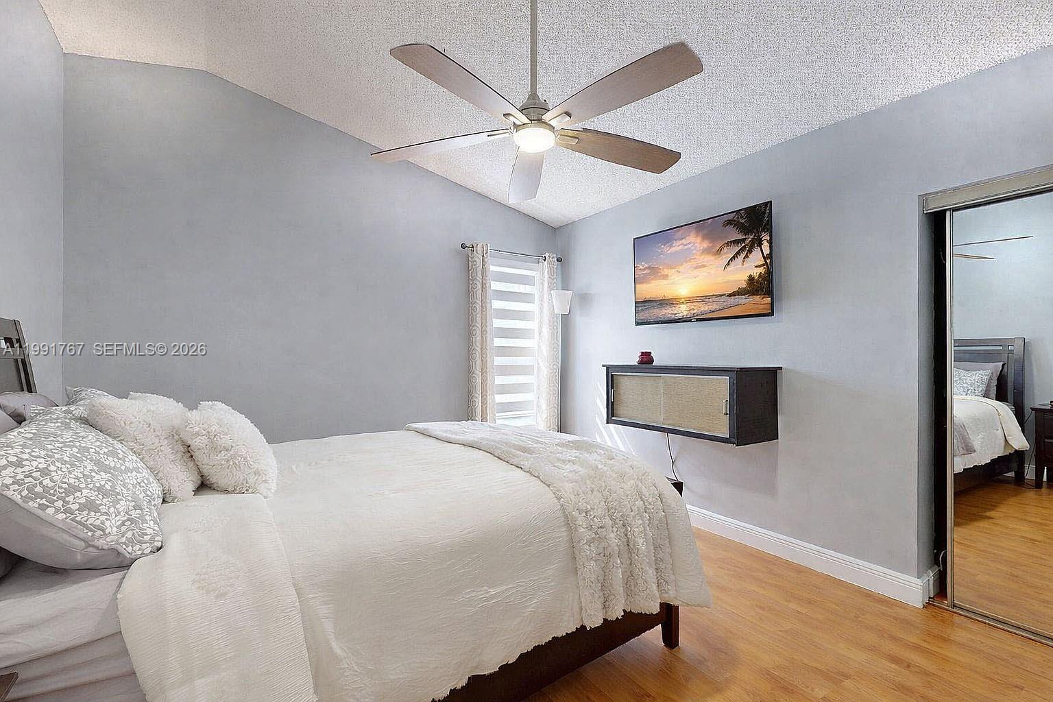 15382 Southwest 153rd Street Miami, FL 33187 - Photo 46 of 65 a bedroom with a bed and a flat screen tv