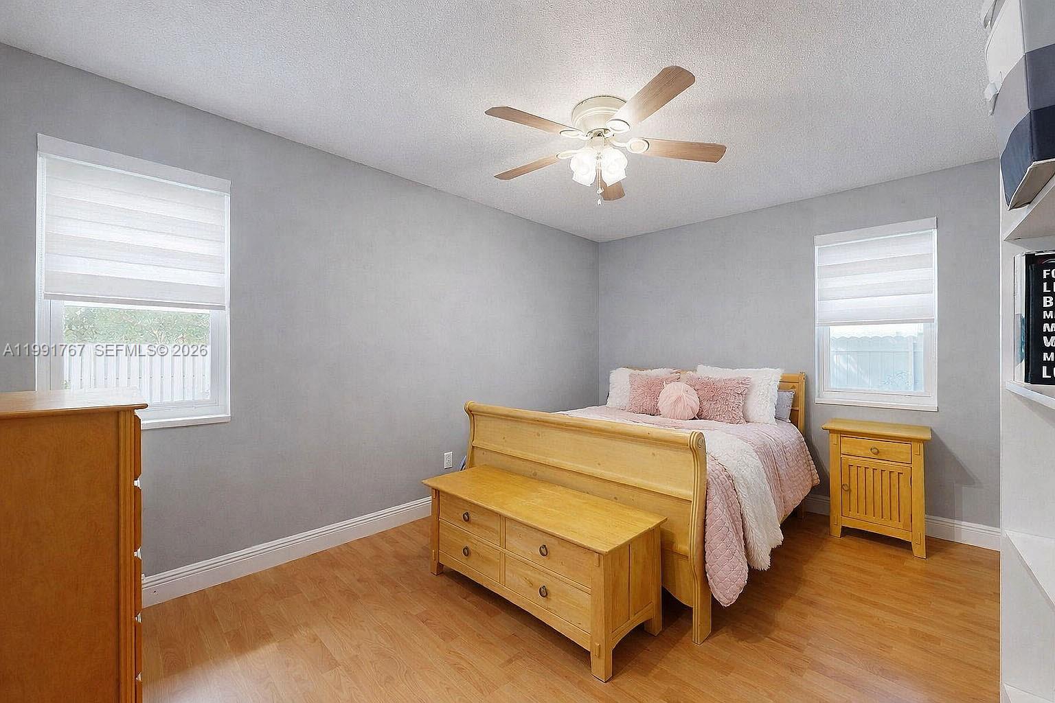 15382 Southwest 153rd Street Miami, FL 33187 - Photo 52 of 65 a bedroom with a bed and a chandelier