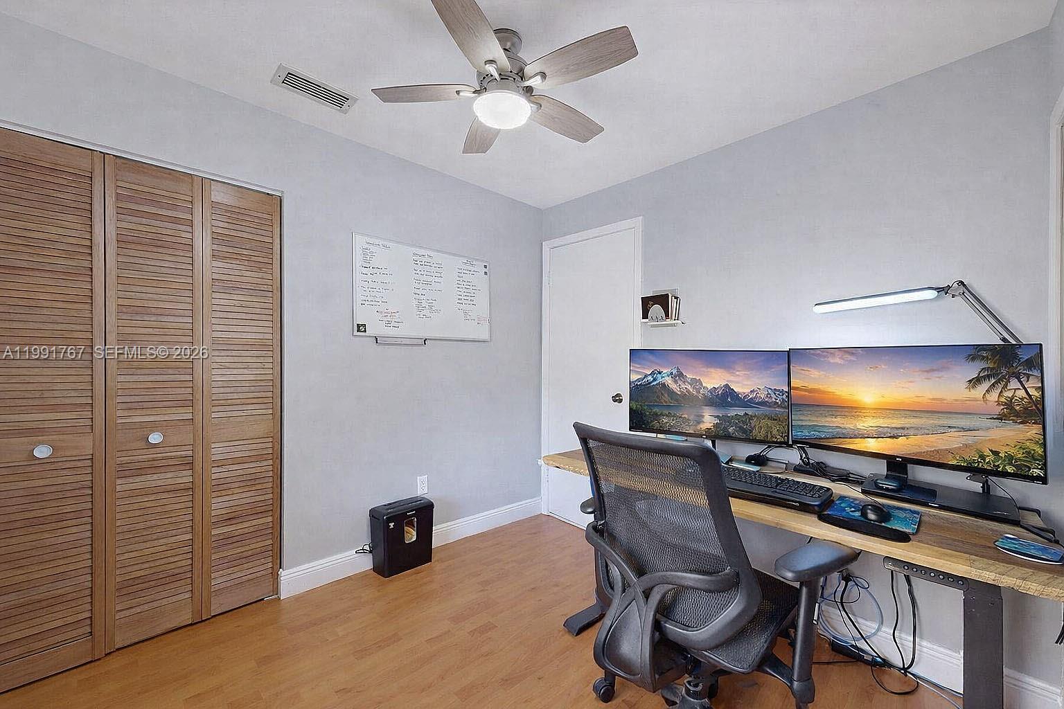 15382 Southwest 153rd Street Miami, FL 33187 - Photo 54 of 65 a view of a workspace with furniture and a flat screen tv