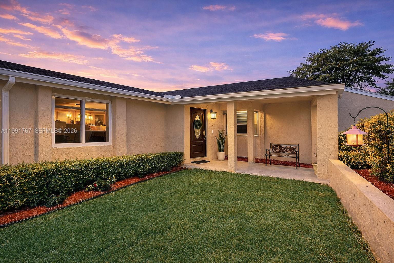 15382 Southwest 153rd Street Miami, FL 33187 - Photo 58 of 65 a front view of a house with a yard