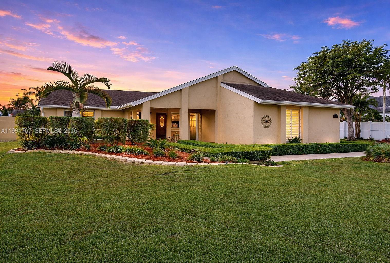 15382 Southwest 153rd Street Miami, FL 33187 - Photo 61 of 65 a front view of a house with a garden and yard