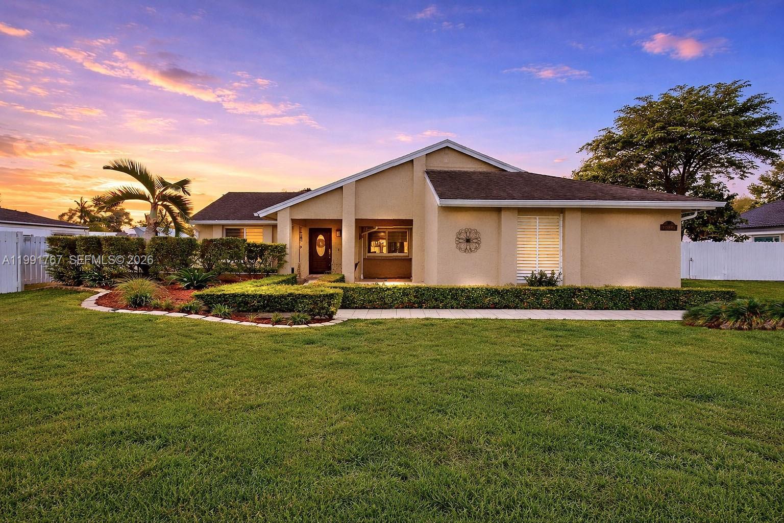 15382 Southwest 153rd Street Miami, FL 33187 - Photo 63 of 65 a front view of house with yard and green space