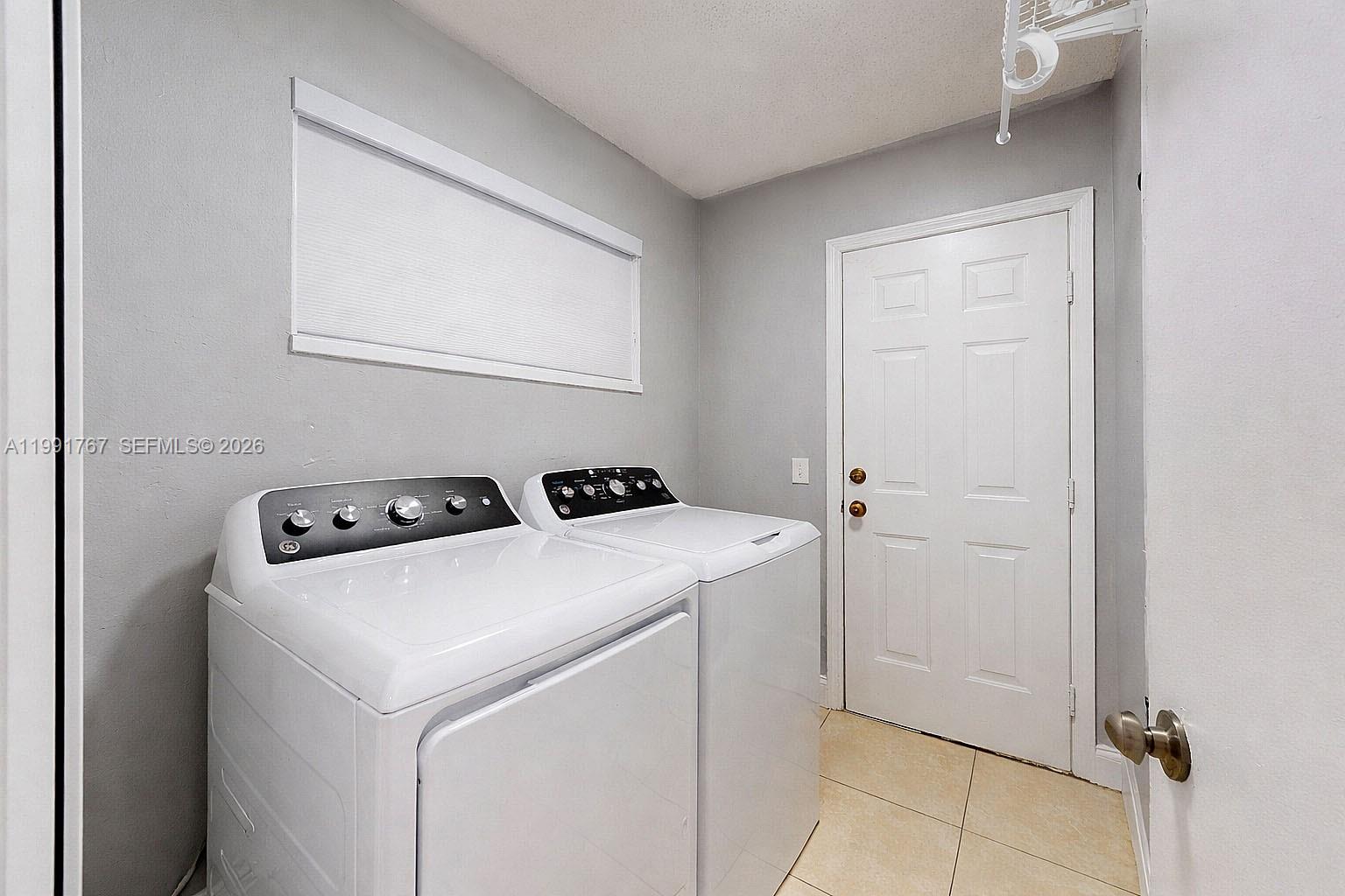 15382 Southwest 153rd Street Miami, FL 33187 - Photo 65 of 65 a utility room with dryer and washer