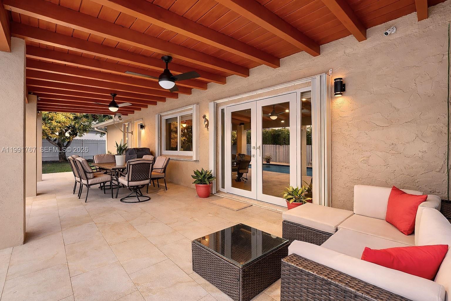 15382 Southwest 153rd Street Miami, FL 33187 - Photo 9 of 65 a outdoor living space with furniture and a potted plant