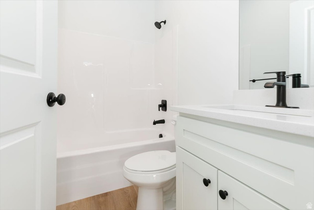 314 North 200 West Logan, UT 84321 - Photo 19 of 37 Bathroom featuring vanity, light wood-style floors, and shower combination
