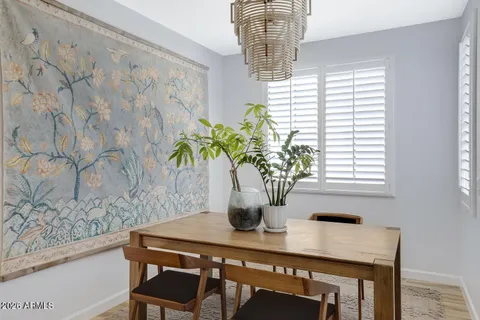 a table with a vase and flowers on it