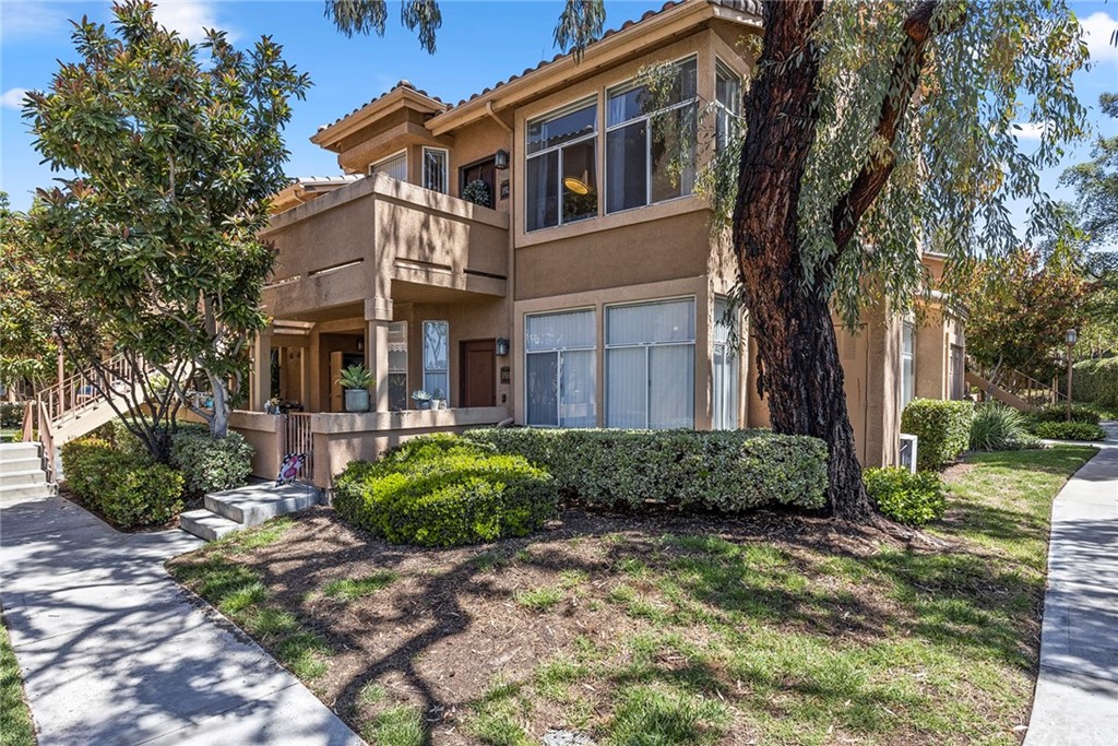 19431 Rue De Valore, Unit 35L Lake Forest, CA 92610 - Photo 1 of 1 a front view of a house with garden